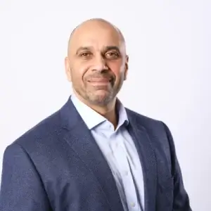 An image of Amrik Johal, smiling at the camera.