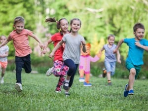 A group of children running together with a System C child character.