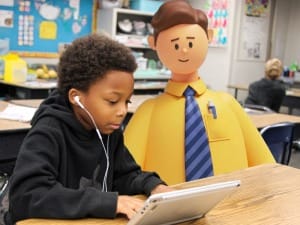 A picture of a child with a System C education worker on an electronic device.