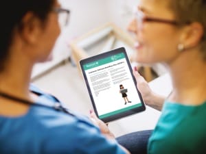 A picture of 2 healthcare professionals viewing the CDW+ brochure on an electronic device.