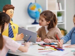 A picture of school children looking at an electronic device held by a System C social care character.